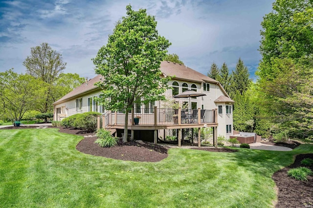 rear view of property with a hot tub, a wooden deck, and a lawn