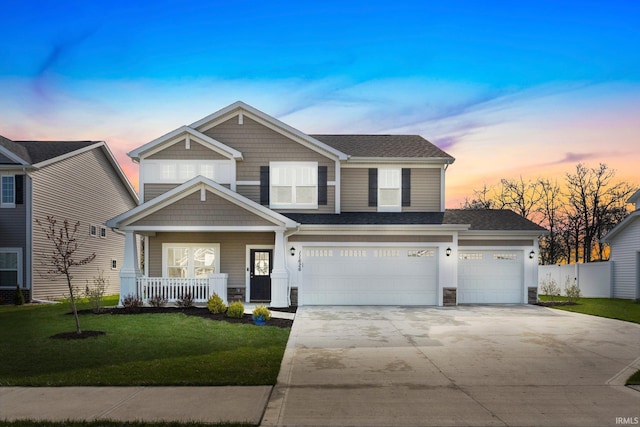 11626 Whistling Trl, Fort Wayne, IN 46818 - view of front facade with driveway, a porch, a shingled roof, stone siding, and a garage