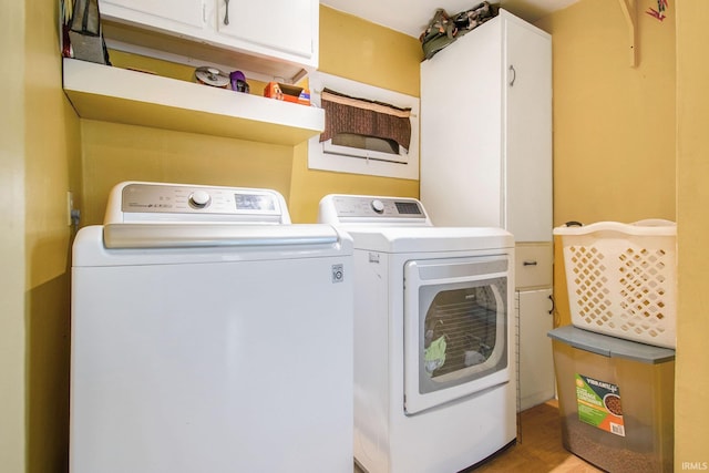 213 E Fourth St, Milford, IN 46542 - washroom featuring cabinet space, separate washer and dryer, and wood finished floors