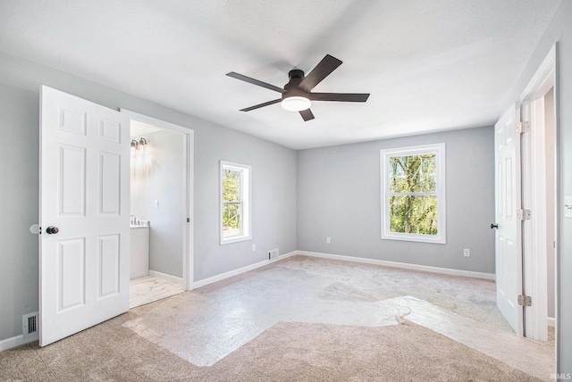 10059 Jefferson Rd, Osceola, IN 46561 - unfurnished bedroom with multiple windows, carpet floors, baseboards, and ceiling fan