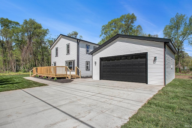 10059 Jefferson Rd, Osceola, IN 46561 - view of front of property featuring a deck, a front lawn, and a detached garage