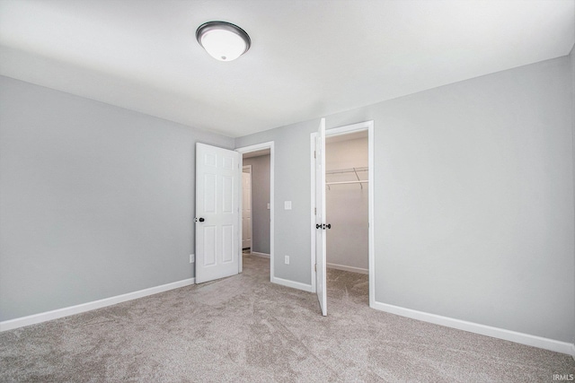 10059 Jefferson Rd, Osceola, IN 46561 - unfurnished bedroom with light colored carpet, a spacious closet, baseboards, and a closet