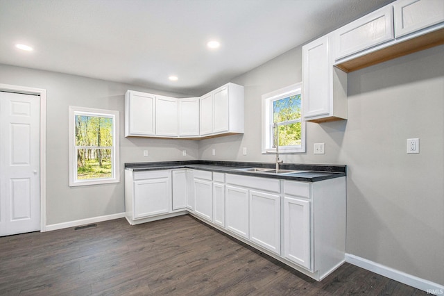 10059 Jefferson Rd, Osceola, IN 46561 - kitchen featuring baseboards, dark countertops, dark wood finished floors, white cabinetry, and recessed lighting