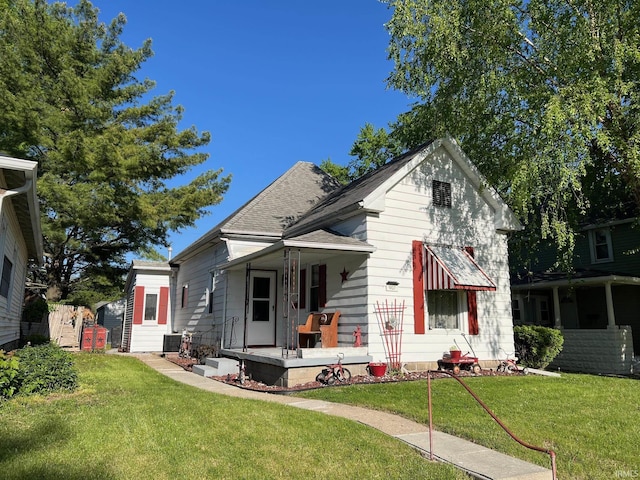 907 S 21st St, Lafayette, IN 47905 - bungalow-style home featuring covered porch, a front yard, cooling unit, and a shingled roof