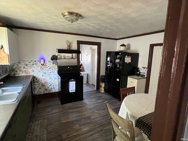 907 S 21st St, Lafayette, IN 47905 - kitchen featuring black appliances, a sink, dark wood-type flooring, baseboards, and a textured ceiling