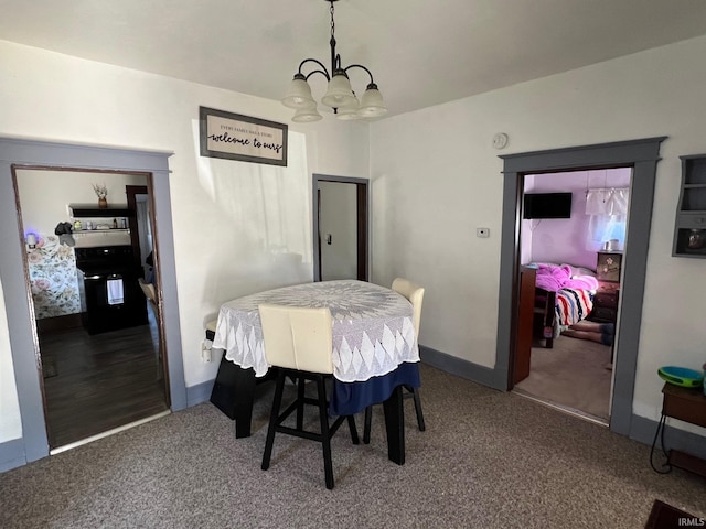 907 S 21st St, Lafayette, IN 47905 - dining area with a chandelier, carpet floors, and baseboards