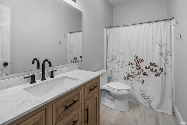 full bathroom with toilet and vanity