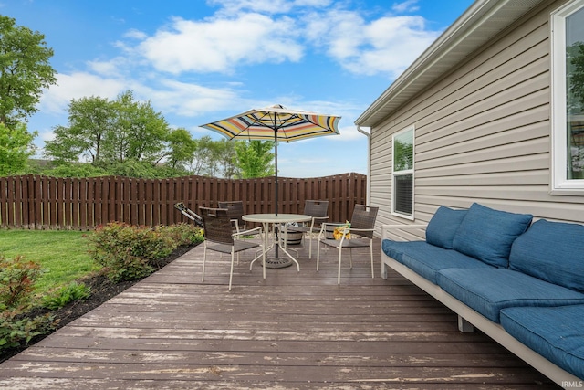 wooden terrace featuring an outdoor living space, outdoor dining space, and fence