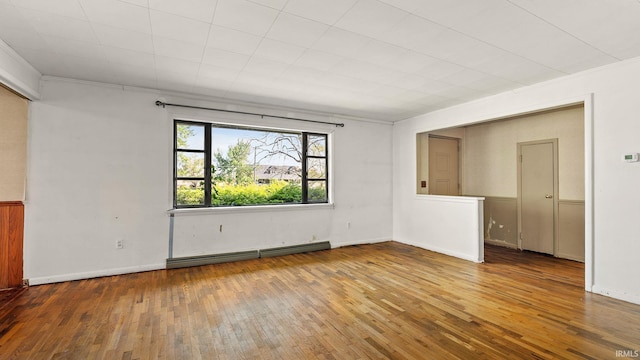 800 E 900 N, Decatur, IN 46733 - spare room featuring a baseboard radiator, hardwood / wood-style flooring, crown molding, and baseboards