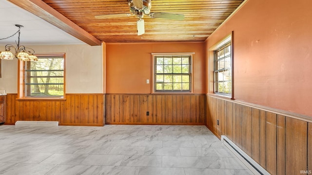800 E 900 N, Decatur, IN 46733 - unfurnished room with baseboard heating, a wainscoted wall, wooden walls, a ceiling fan, and light marble finish flooring