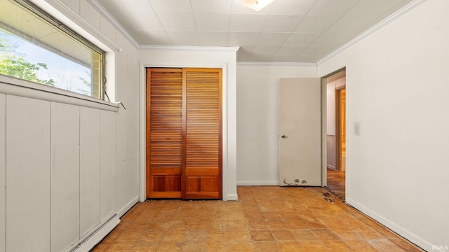 800 E 900 N, Decatur, IN 46733 - unfurnished bedroom featuring a closet, crown molding, a baseboard radiator, and baseboards