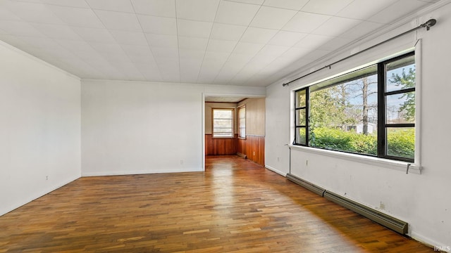 800 E 900 N, Decatur, IN 46733 - spare room featuring baseboard heating, wood finished floors, baseboards, and crown molding