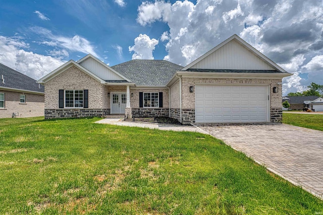 3530 Montgomery Ct, Newburgh, IN 47630 - view of front of home with decorative driveway, brick siding, a front lawn, an attached garage, and french doors
