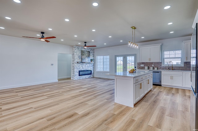 3530 Montgomery Ct, Newburgh, IN 47630 - kitchen featuring dishwasher, open floor plan, a ceiling fan, a kitchen island, and light wood-type flooring