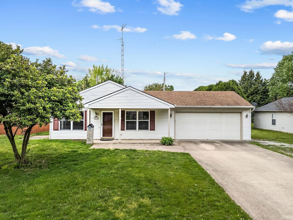 303 W 5th St, North Manchester, IN 46962 - view of front facade with a garage, a front yard, and concrete driveway