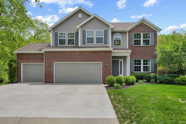 view of front of house featuring a front yard, driveway, an attached garage, brick siding, and a shingled roof