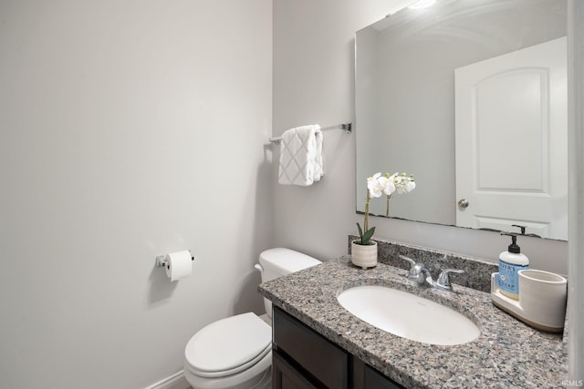bathroom featuring toilet and vanity
