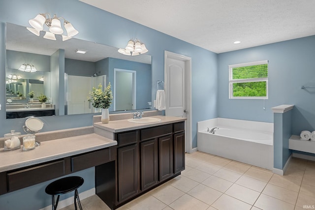full bath featuring a textured ceiling, a garden tub, tile patterned floors, baseboards, and vanity