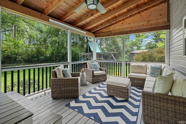 wooden deck featuring outdoor lounge area, ceiling fan, and a lawn