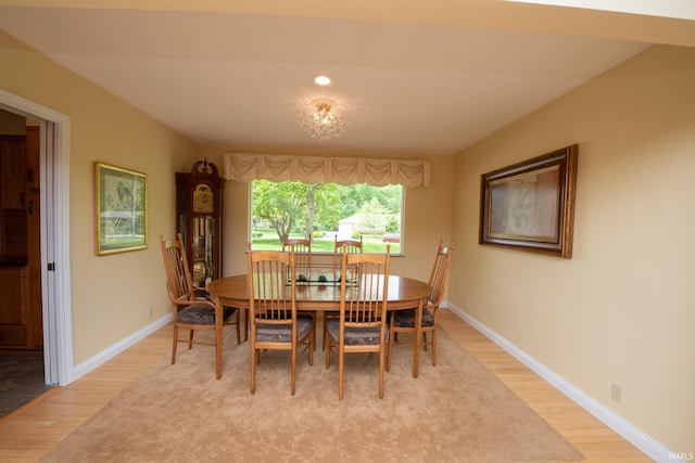 dining area with light wood finished floors, baseboards, and recessed lighting