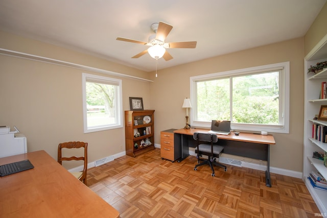 office with a ceiling fan and baseboards