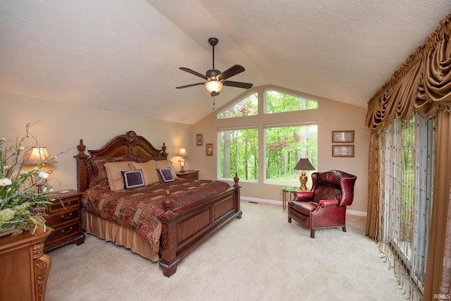 bedroom with light carpet, vaulted ceiling, baseboards, and a ceiling fan