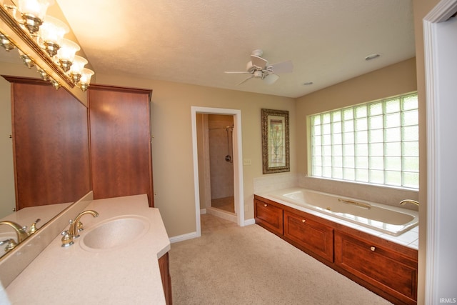 bathroom with a shower stall, a tub with jets, ceiling fan, baseboards, and vanity