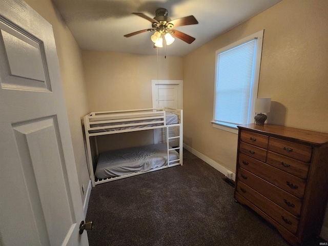 217 E Eichel Ave, Evansville, IN 47711 - bedroom with dark colored carpet, baseboards, and a ceiling fan