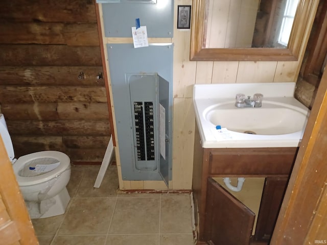403 E Poplar St, Fort Branch, IN 47648 - bathroom featuring vanity, tile patterned flooring, toilet, electric panel, and log walls