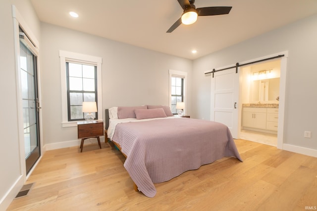 735 E Holland Dr, Bloomington, IN 47401 - bedroom with a barn door, light wood finished floors, baseboards, and recessed lighting