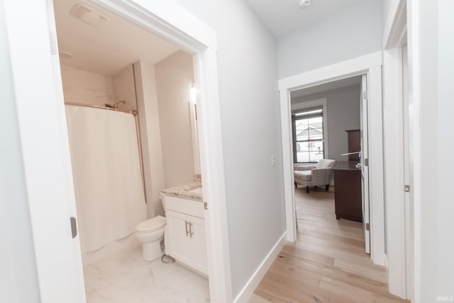 735 E Holland Dr, Bloomington, IN 47401 - corridor featuring light wood-style flooring and baseboards