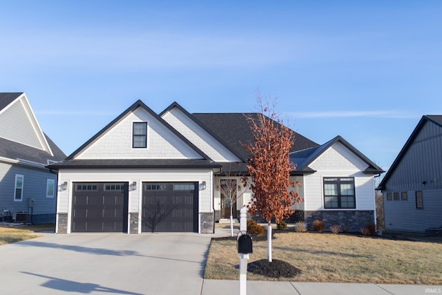 735 E Holland Dr, Bloomington, IN 47401 - view of front of house featuring stone siding, driveway, and a front yard