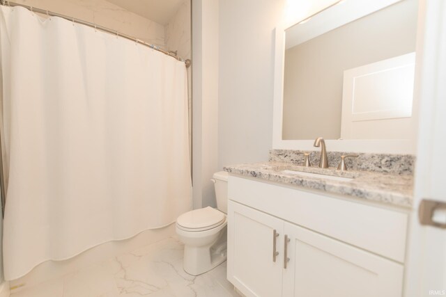 735 E Holland Dr, Bloomington, IN 47401 - full bathroom featuring marble look tile flooring, toilet, vanity, and a shower with curtain