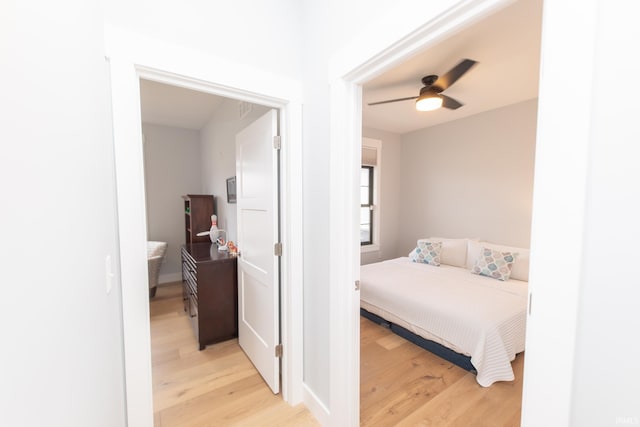 735 E Holland Dr, Bloomington, IN 47401 - bedroom with light wood finished floors and ceiling fan