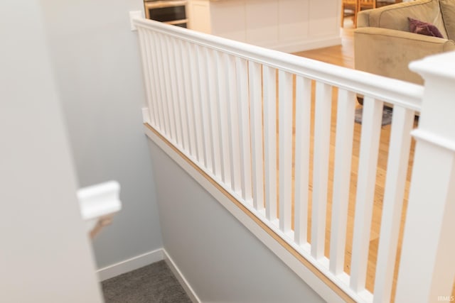 735 E Holland Dr, Bloomington, IN 47401 - staircase featuring baseboards and carpet