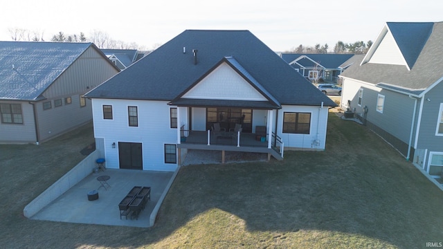 735 E Holland Dr, Bloomington, IN 47401 - back of house featuring a patio, a yard, and a shingled roof