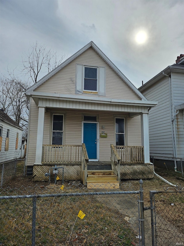 view of front of home with covered porch, a gate, and a fenced front yard