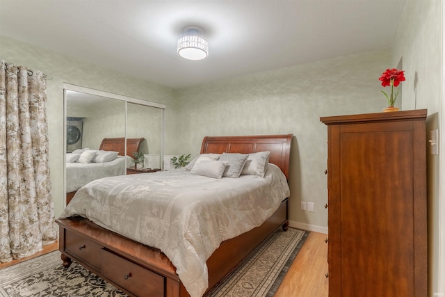 bedroom featuring light wood-style flooring and a closet