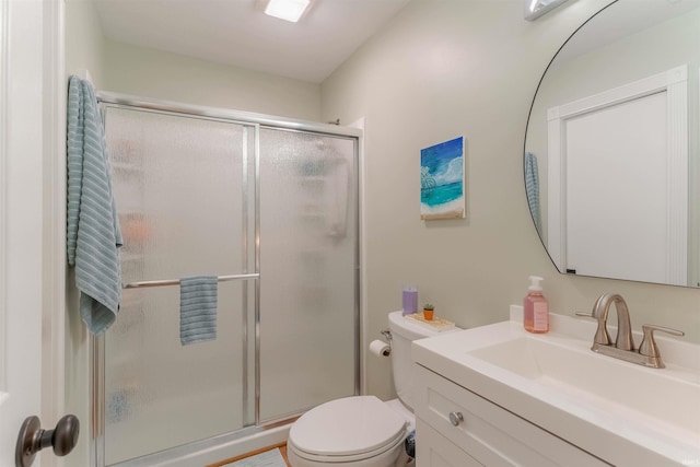 full bath featuring a stall shower, toilet, and vanity