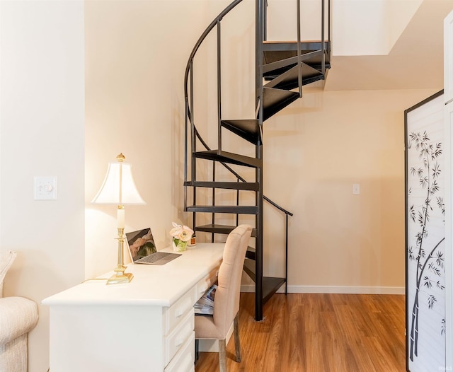 home office featuring light wood-type flooring and baseboards