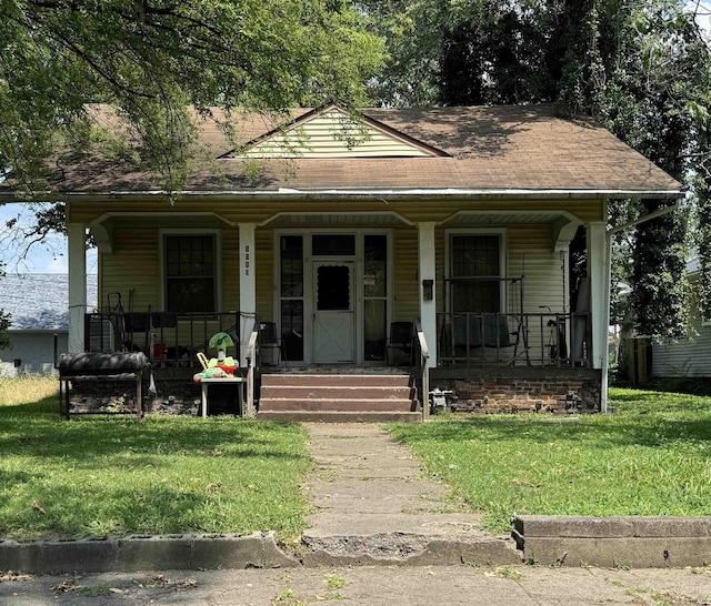 bungalow-style home with covered porch and a front yard