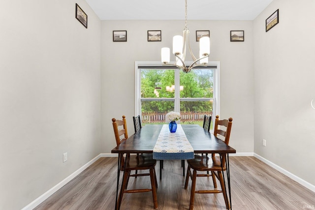 7689 Accio Cv, Fort Wayne, IN 46835 - dining area featuring a chandelier, wood finished floors, and baseboards