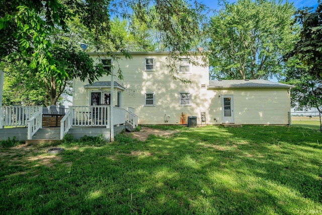 293 N 1100 E, Greentown, IN 46936 - back of house featuring a wooden deck, a lawn, and central AC