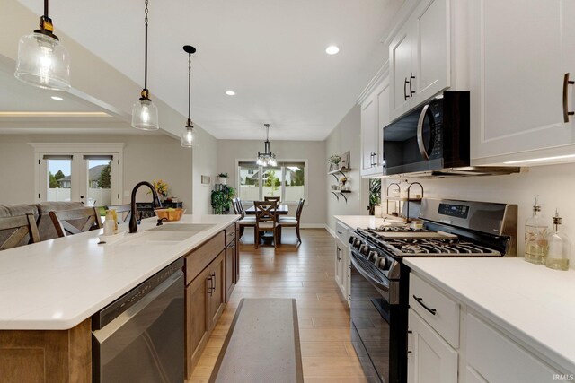 201 Thoroughbred Ln, Auburn, IN 46706 - kitchen featuring appliances with stainless steel finishes, a sink, light wood-type flooring, recessed lighting, and light countertops