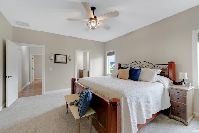 201 Thoroughbred Ln, Auburn, IN 46706 - bedroom featuring light carpet, baseboards, a ceiling fan, and ensuite bathroom