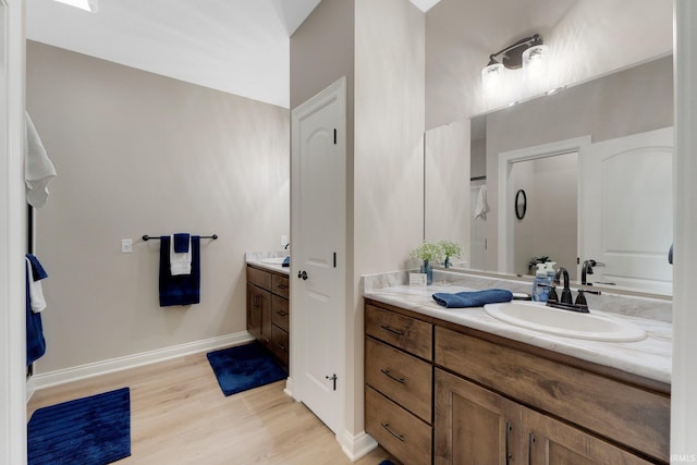 201 Thoroughbred Ln, Auburn, IN 46706 - bathroom with vanity, wood finished floors, baseboards, and a shower
