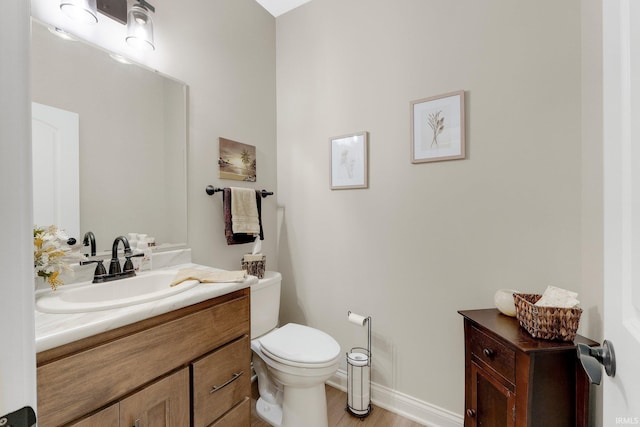 201 Thoroughbred Ln, Auburn, IN 46706 - bathroom with vanity, toilet, wood finished floors, and baseboards