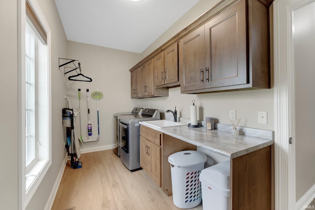 201 Thoroughbred Ln, Auburn, IN 46706 - clothes washing area featuring cabinet space, independent washer and dryer, light wood-style floors, and baseboards