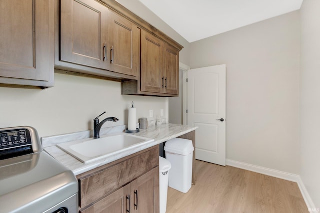 201 Thoroughbred Ln, Auburn, IN 46706 - clothes washing area featuring washer / dryer, cabinet space, light wood finished floors, and baseboards