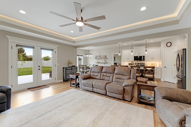 201 Thoroughbred Ln, Auburn, IN 46706 - living area featuring a raised ceiling, ceiling fan, light wood-style floors, recessed lighting, and french doors